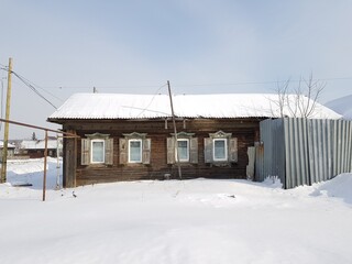 Old stone village house covered with snow