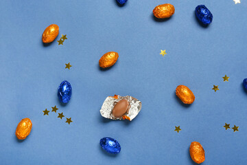 Sweet chocolate eggs on color background