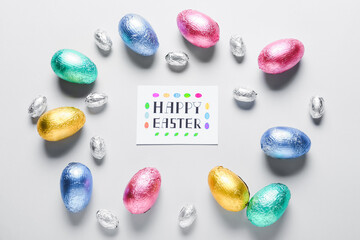 Beautiful composition with chocolate Easter eggs on light background