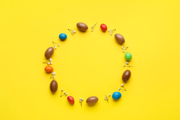 Composition with chocolate Easter eggs on color background