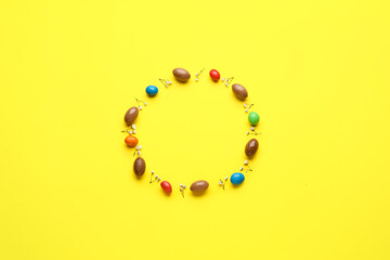 Composition with chocolate Easter eggs on color background