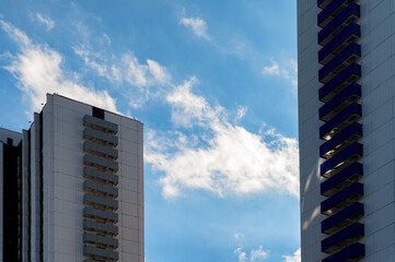 Blue-gray modern multi-storey building against blue sky