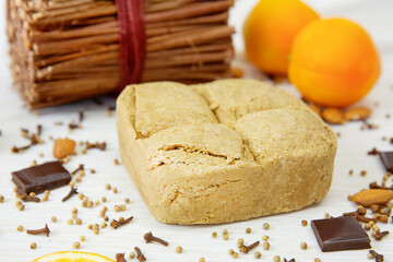 A large piece of halva on a background of oranges 