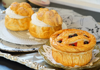 Time for dessert of pies and cream puffs on the table © aozora