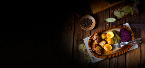 Rustic Snirtjebraten with red cabbage and cucumber