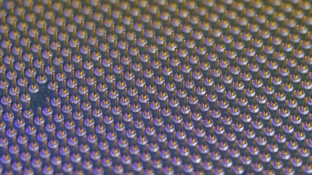 Soket pins on CPU chip processor in light of different color. Electronic and computing equipment, computer hardware. Macro shot microprocessor unit of PC hardware system