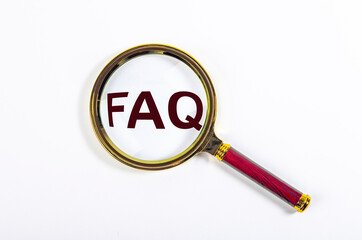 FAQ acronym through loupe on white background