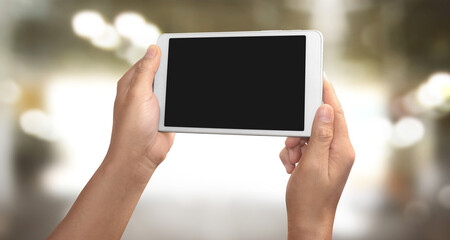 Hands holding a tablet touch computer gadget