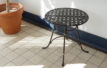 Houseplants and table on the terrace on a sunny day