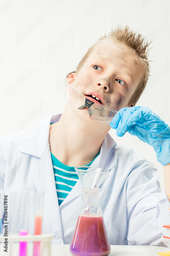 Wall mural funny boy dressed as chemist with dirty face after a failed experiment