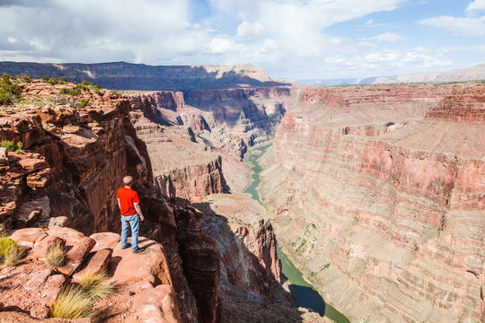 Man stading on the edge of Grand Canyon, USA