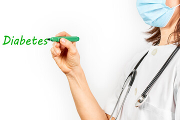 Doctor with mask writing the word diabetes with a marker pen green