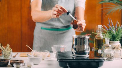 Woman Preparing Homemade Soap with Essential Oil Extracts