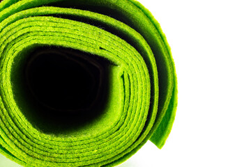 Fototapeta na wymiar roll of bright green dense fabric on a white background, side view, close-up, background, texture