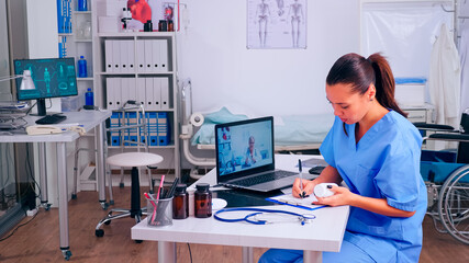 Assistant taking notes listening advice of remote doctor during video call, virtual health conference, training webinar concept. Medical physician talking diagnoses patients, online meeting