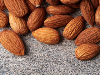 Almond in a bowl on wooden background with copy space