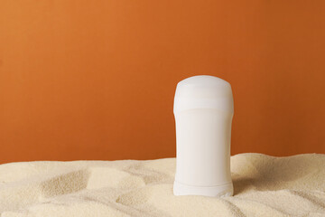 Deodorant or antiperspirant white bottle template on the sand, summer body care products