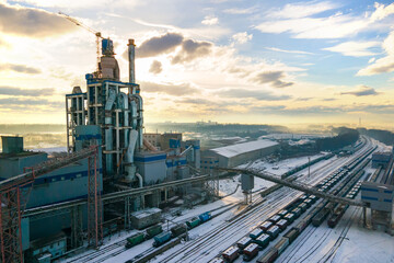 Aerial view of cement plant with high factory structure at industrial production area.