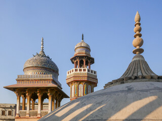 Landscape view of minaret, dome and kiosk from the roof of landmark mughal era Wazir Khan mosque in the walled city of Lahore, Punjab, Pakistan