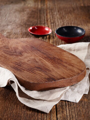 wood cutting board and utensils on wooden table