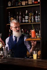 senor bartender with a bloody mary cocktail