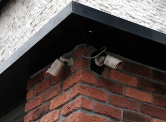 Real time Modern Online Security CCTV camera surveillance system. An outdoor security camera installed on a brick wall. Equipment system service for safety life or asset.