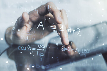 Creative scientific formula concept with finger clicks on a digital tablet on background....