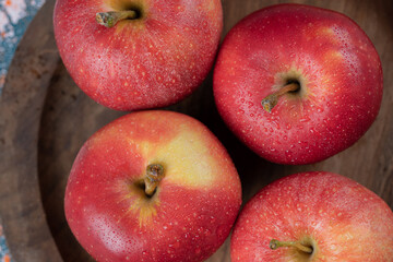 Juicy apples isolated on a wooden platter