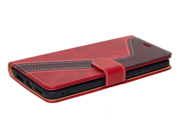 Mobile phone case isolated. Close-up of a smartphone in a red brown leather mobile phone case with...