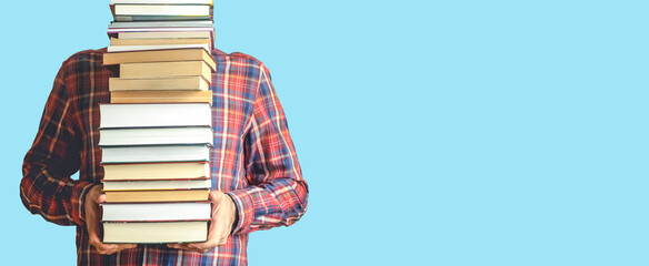 Student with books on a blank colored banner background. Education, reading and study background...