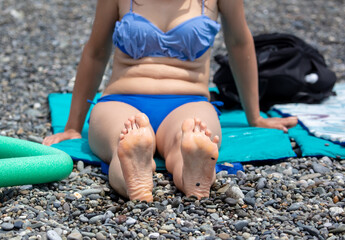 Fototapeta na wymiar Girl in a swimsuit on the beach