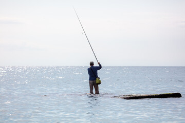 A man with a fishing rod is fishing