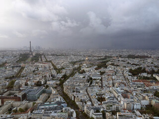 Fototapeta na wymiar Panoramic view of Paris from the top floor of skyscraper, from above, in bad stormy weather, gray cloudy sky