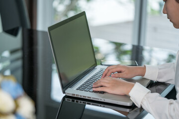 Closeup woman hand using computer laptop. Using online connect technology for business, education and communication.