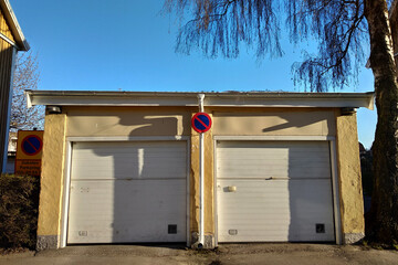 Outdoor garage foe two cars with no parking sign in front.