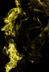 Yellow smoke isolated on black background. Abstraction