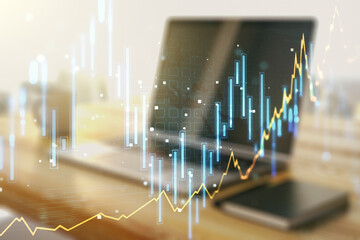 Double exposure of abstract creative financial chart and modern desktop with laptop on background, research and strategy concept