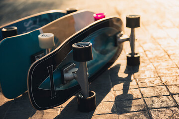 Close up surf skate or skateboard at park sunset