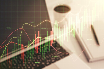 Multi exposure of abstract financial graph on laptop background, financial and trading concept