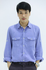 Handsome smiling Asian business man in blue shirt standing with Pick pocket pants arms, on white background. Concept business woman manager.