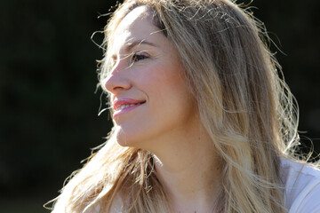 woman face portrait outdoors with sun light