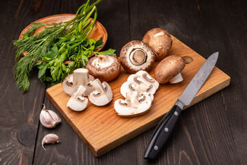 sliced mushrooms on a chopping board with herbs