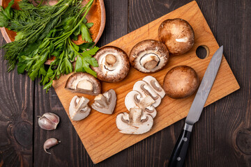 sliced mushrooms on a chopping board with herbs