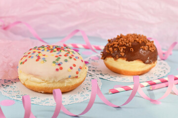 Traditional German dessert similar to doughnut with no hole called 'Berliner Pfannkuchen' made from sweet yeast dough fried in fat glazed with white chocolate and sprinkles