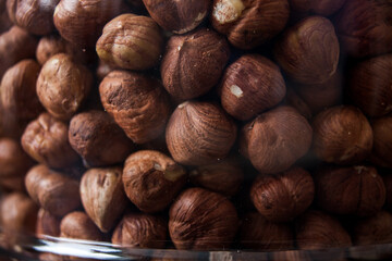 Closeup on hazel nuts in glass container
