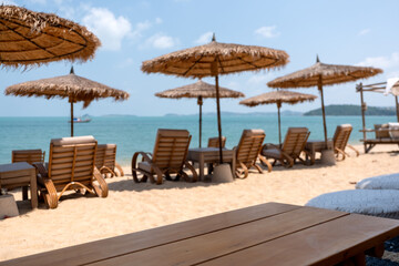 Wooden table and chairs at tropical beach cafe