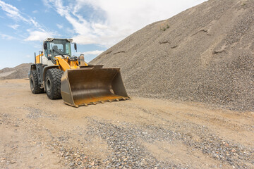 Excavator at a construction site in the extraction of stone and rock