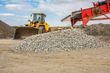 Excavator at a construction site in the extraction of stone and rock