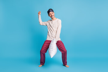Photo portrait full body view of funny guy riding pillow isolated on vivid blue colored background