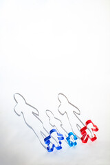 Family of ginger bread forms on white background along with their long shadows